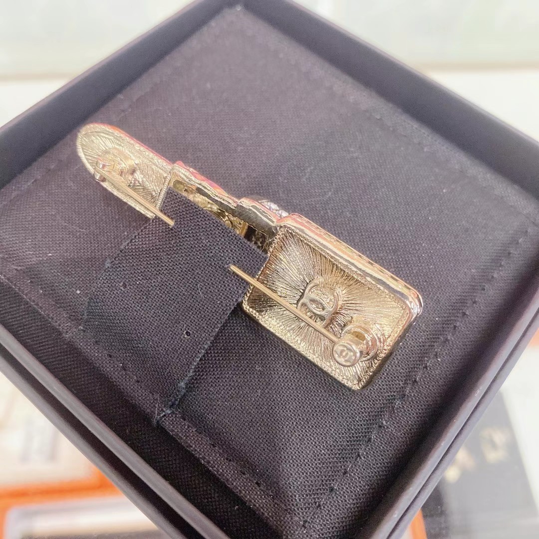 Chanel lipstick-shaped brooch with rhinestones63440389771011111